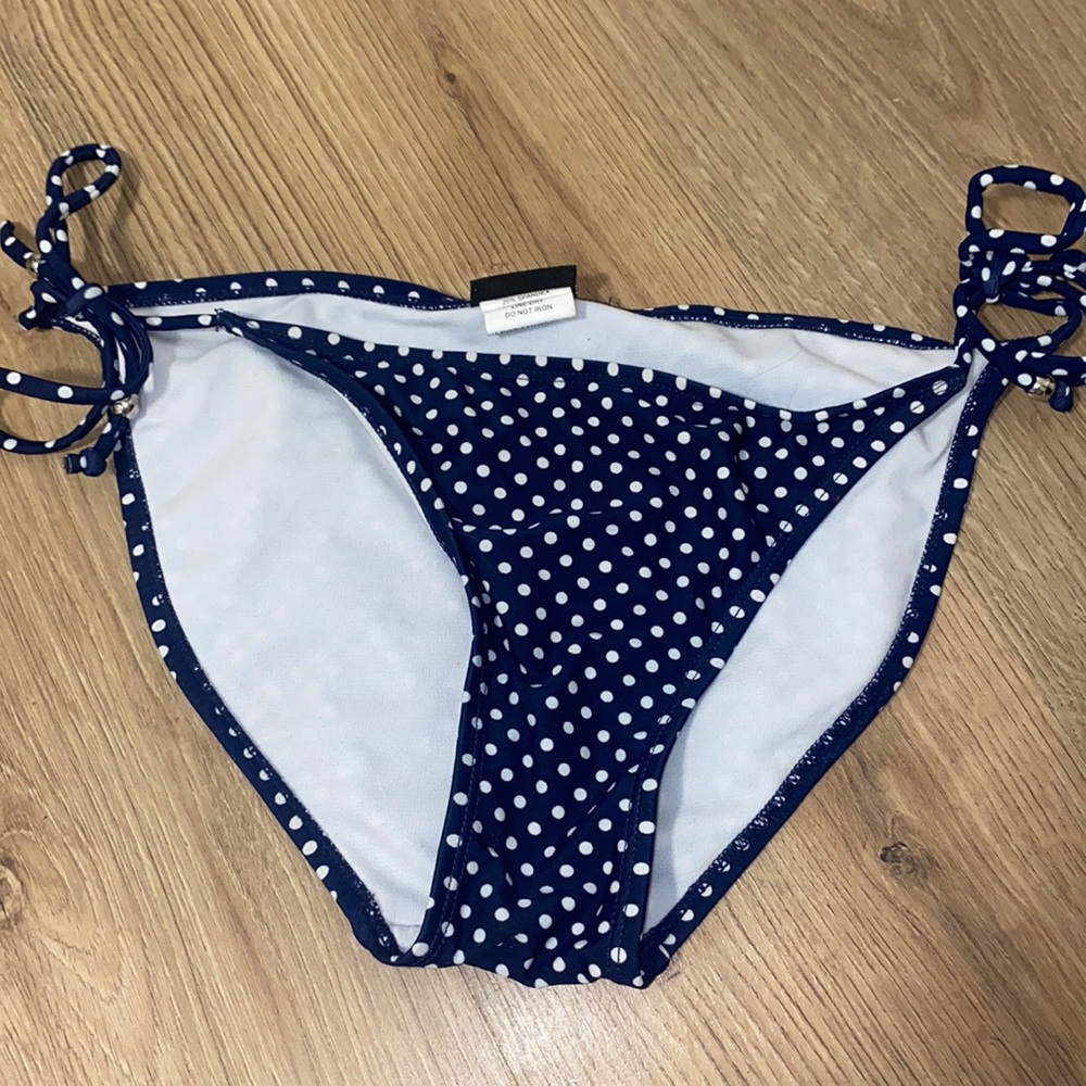 Ingear size medium bathing suit bottom with ties on the side.